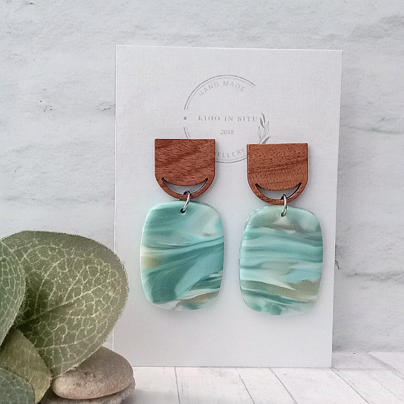 Make a splash with these handmade, eye-catching earrings! Featuring a soft blue and grey marble effect polymer clay that reflects the ocean