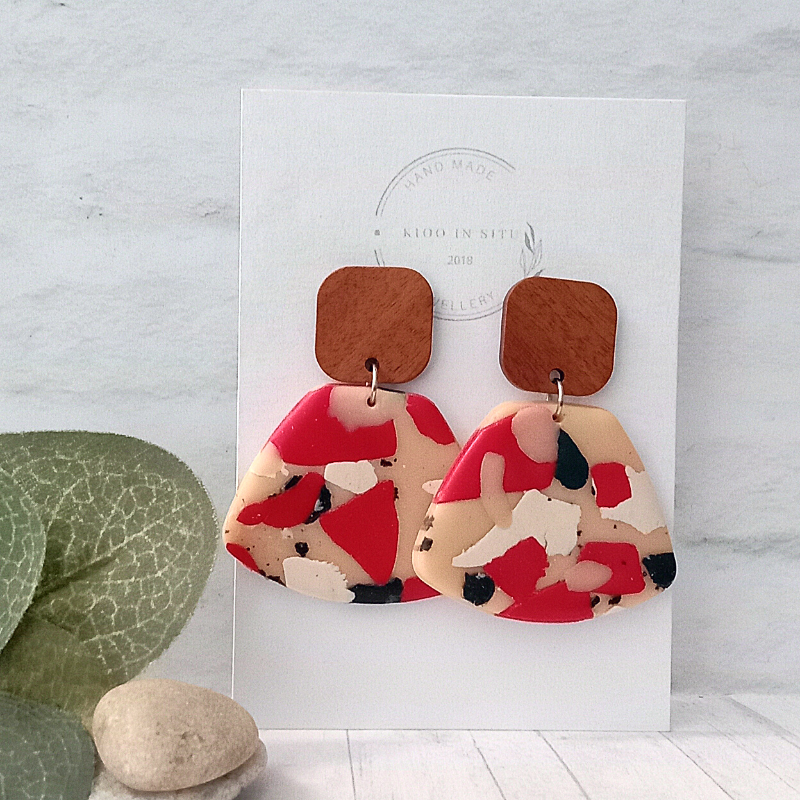 These Polymer Clay Earrings draw attention with a modern, minimalist design and a splash of vibrant red